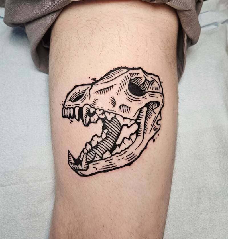 Bold linework wolf skull side profile tattoo for men