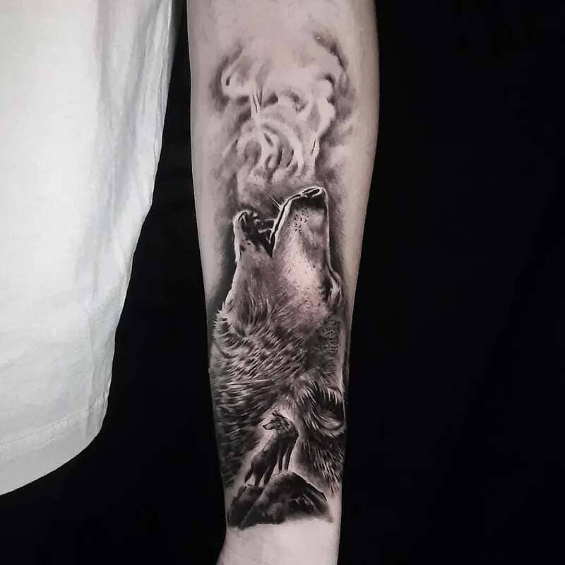 Realistic howling wolf forearm tattoo with smoke effect for men