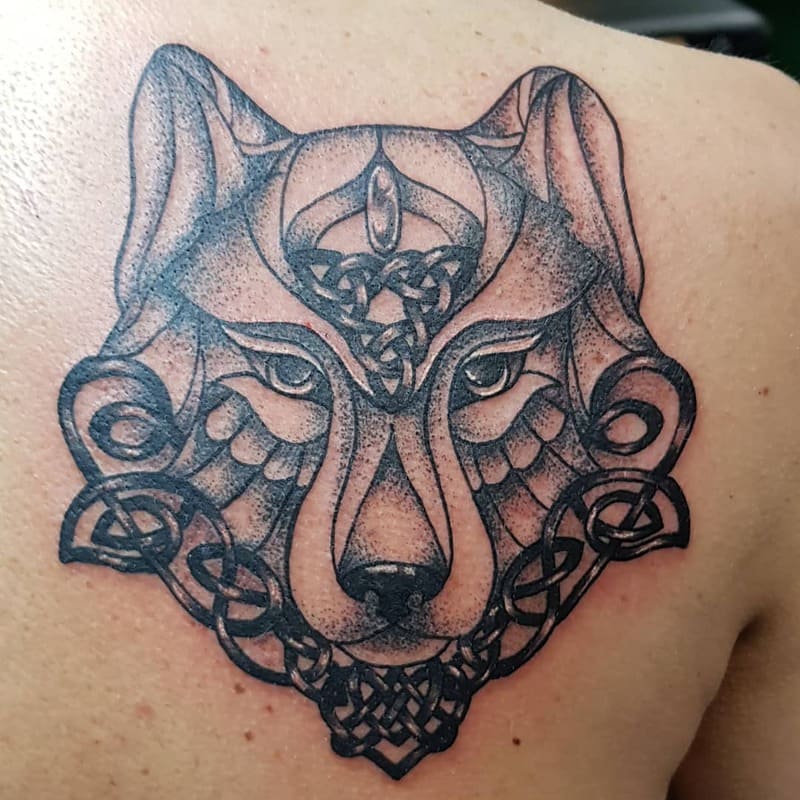 Celtic wolf head back tattoo with trinity knots for men