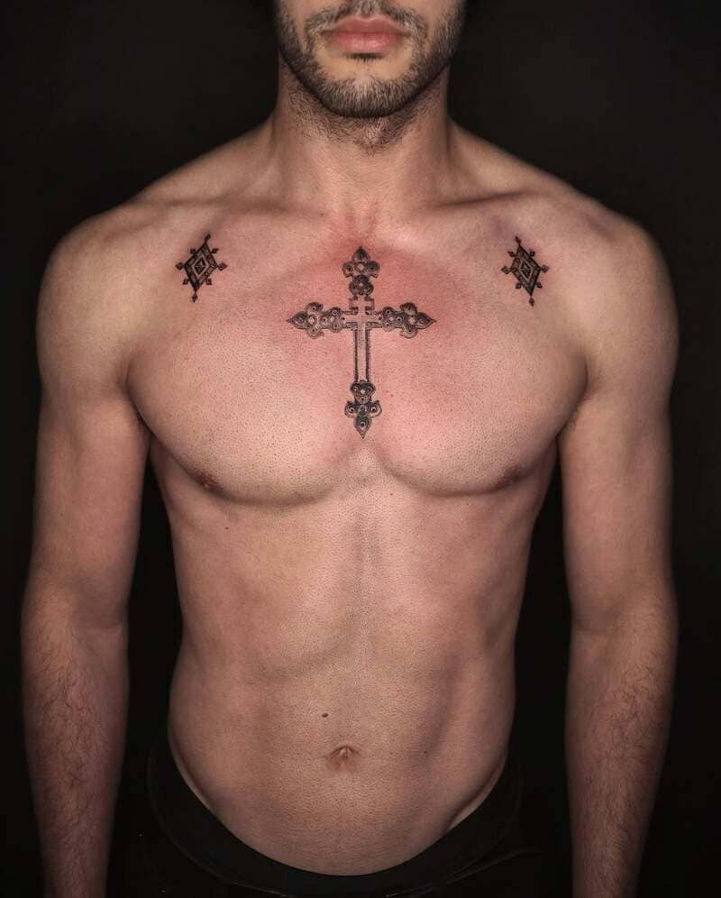 ornate-cross-star-small-chest-tattoo-men