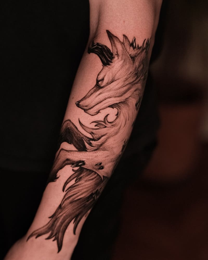 Artistic wolf profile forearm tattoo with flowing lines for men