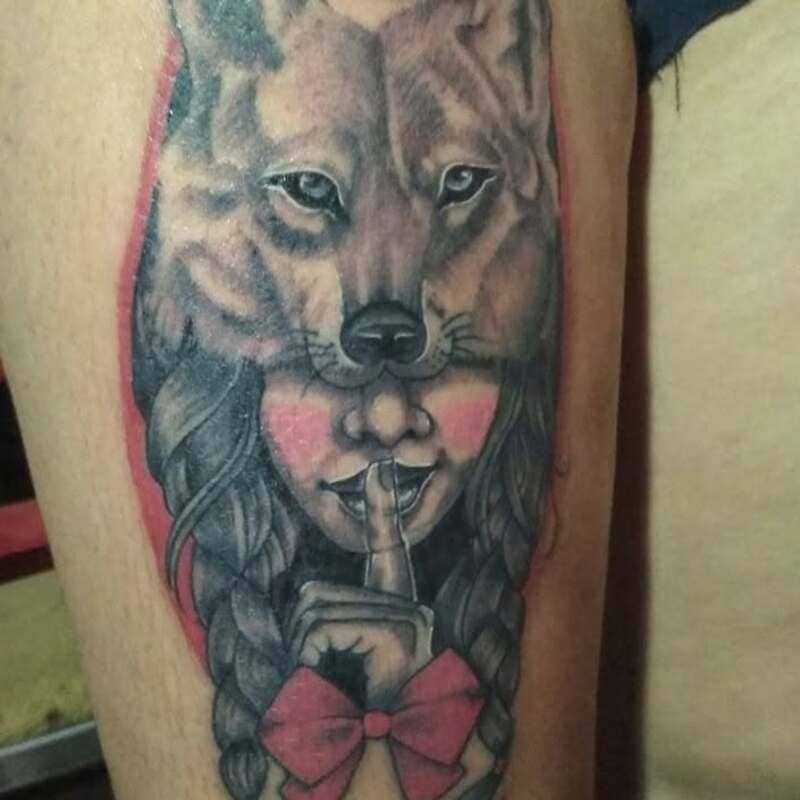 Wolf mask girl portrait tattoo with red accents for men