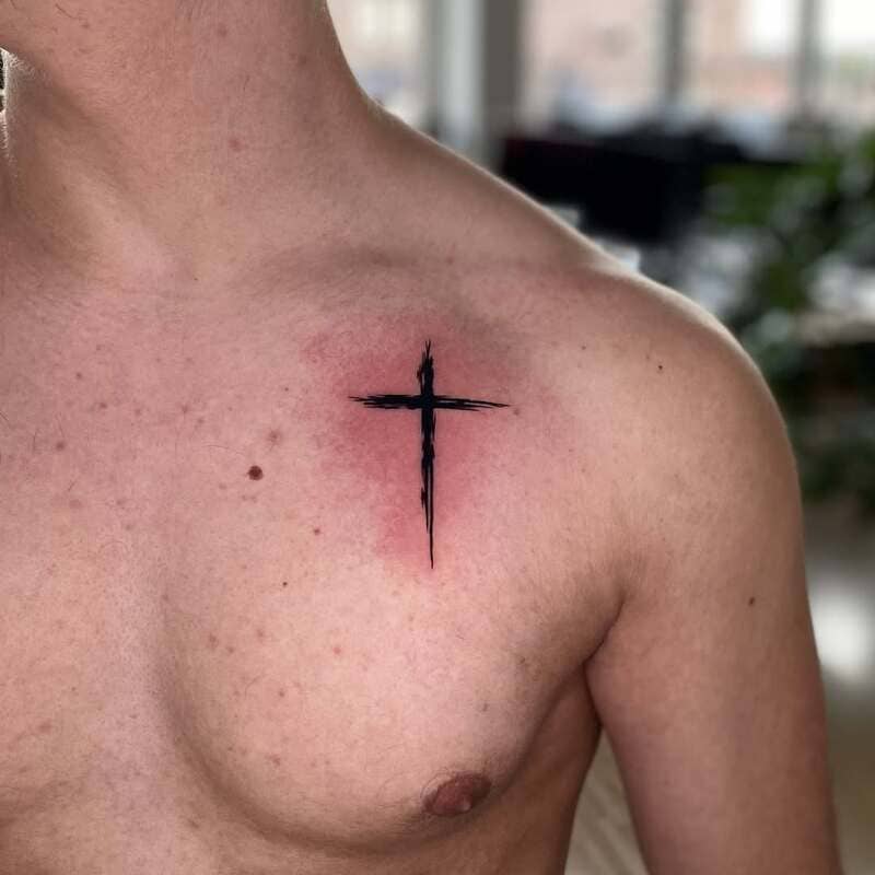 brushstroke-cross-small-chest-tattoo-men