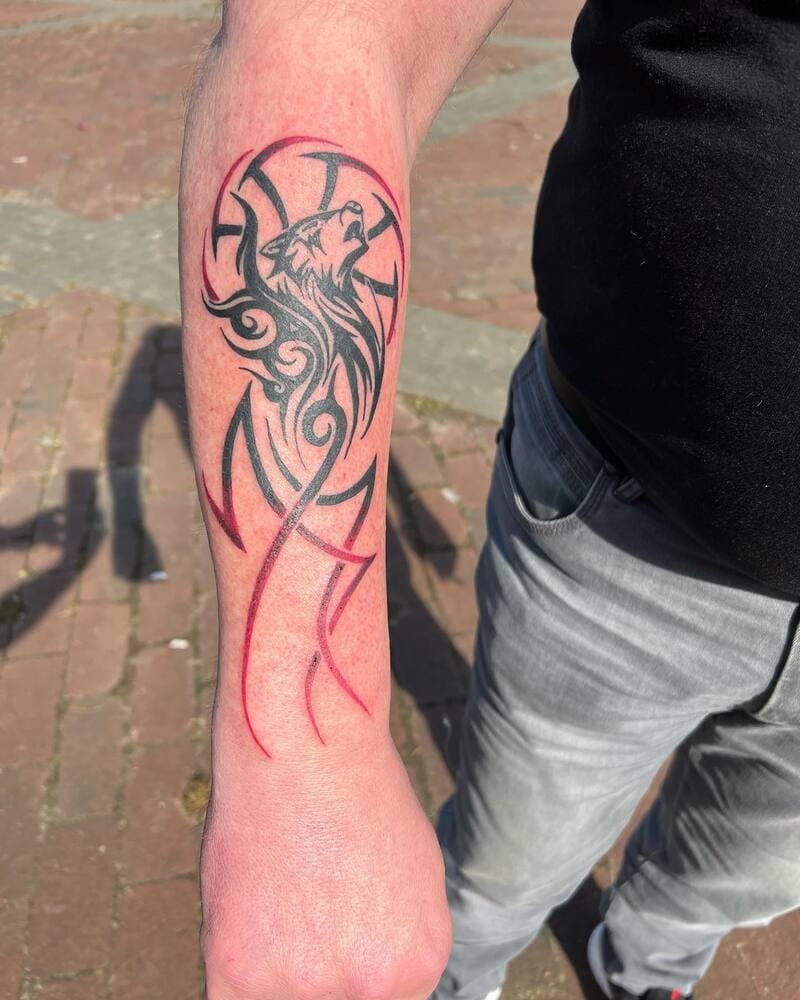 Howling tribal wolf forearm tattoo for men