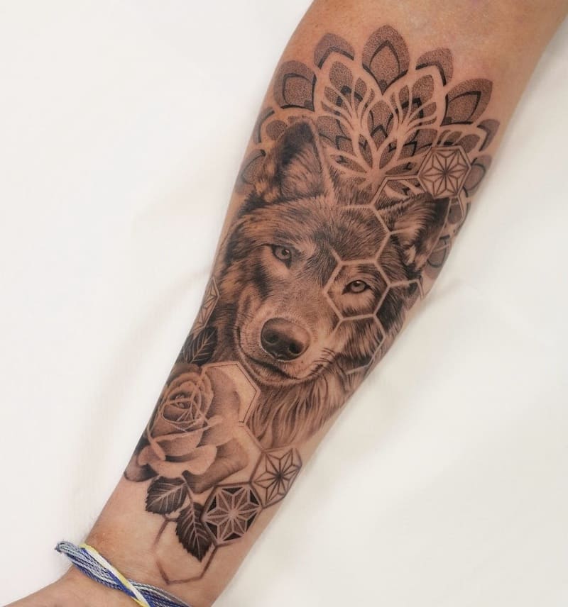 Geometric wolf tattoo with mandala and rose elements for men