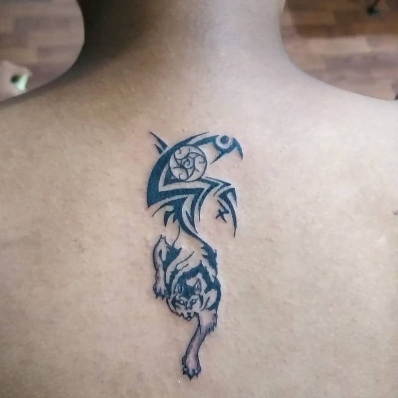 Vertical tribal wolf back tattoo for men