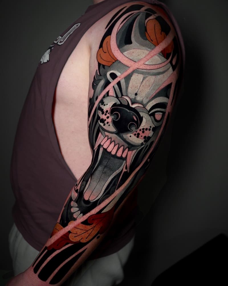 Neo-traditional wolf sleeve tattoo with orange and pink accents for men