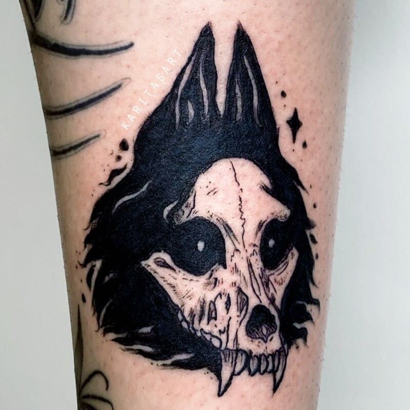 Dark wolf skull with solid black fill tattoo for men