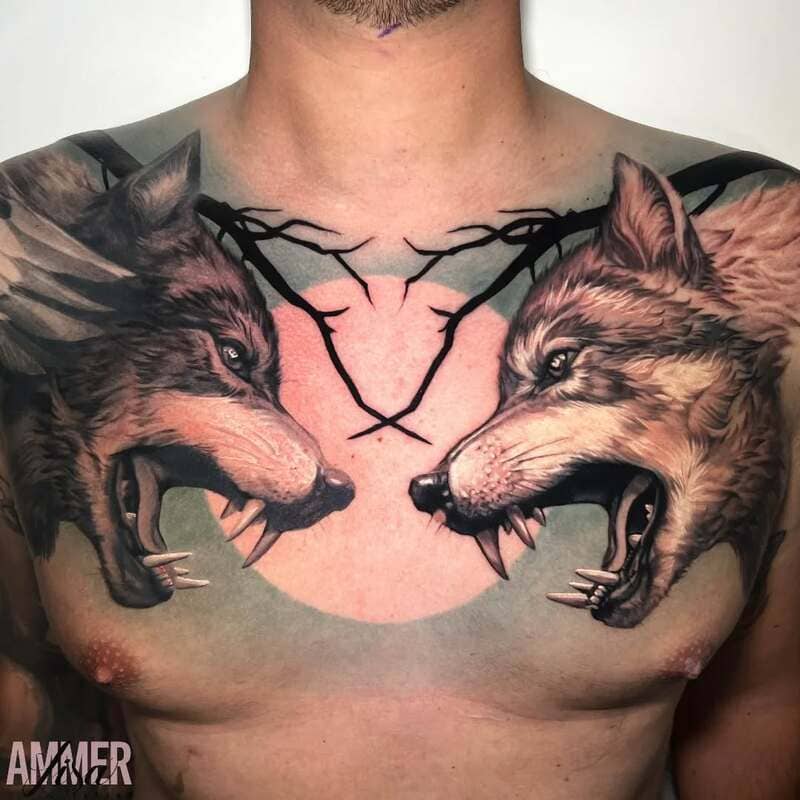 Dueling wolves chest tattoo with dark branches for men