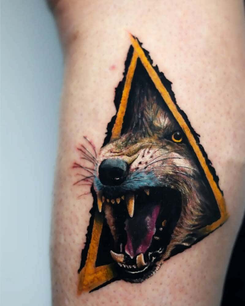Aggressive wolf in yellow triangle arm tattoo for men