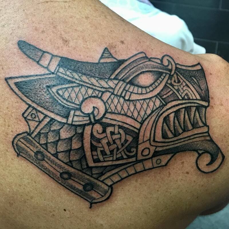 Celtic tribal wolf head tattoo with knotwork patterns for men