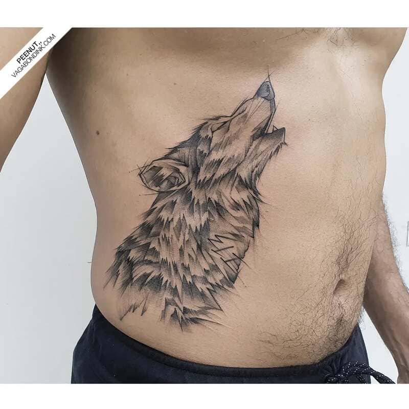 Side body howling wolf tattoo with detailed fur for men