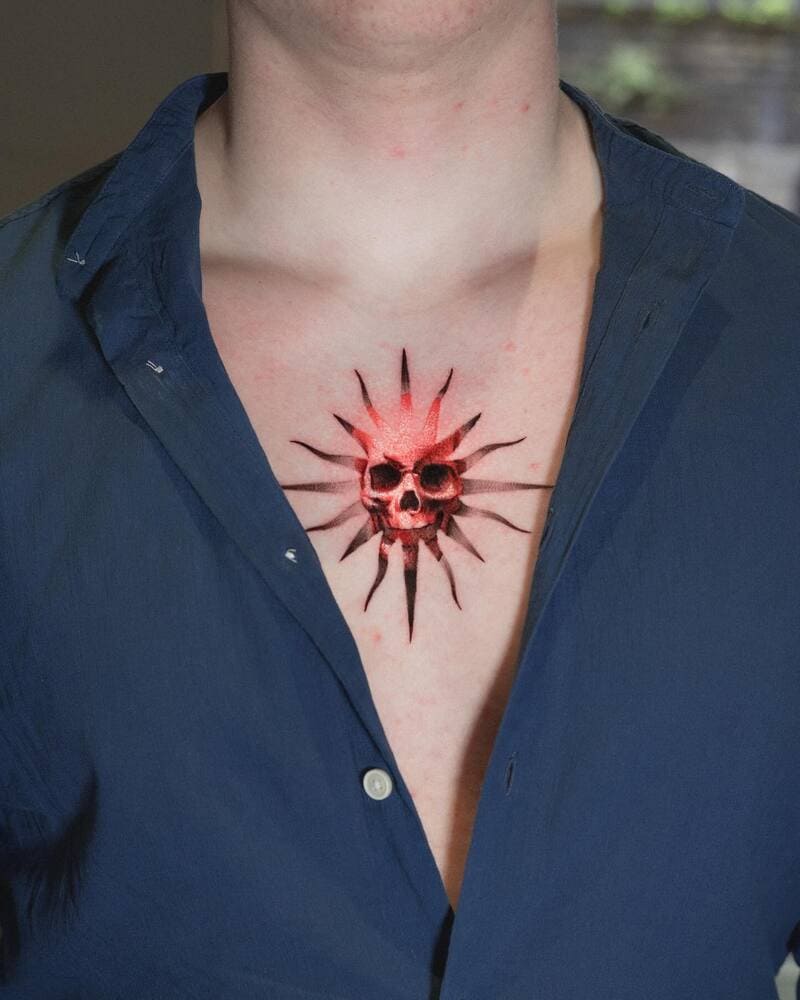 skull-sunburst-small-center-chest-tattoo-men
