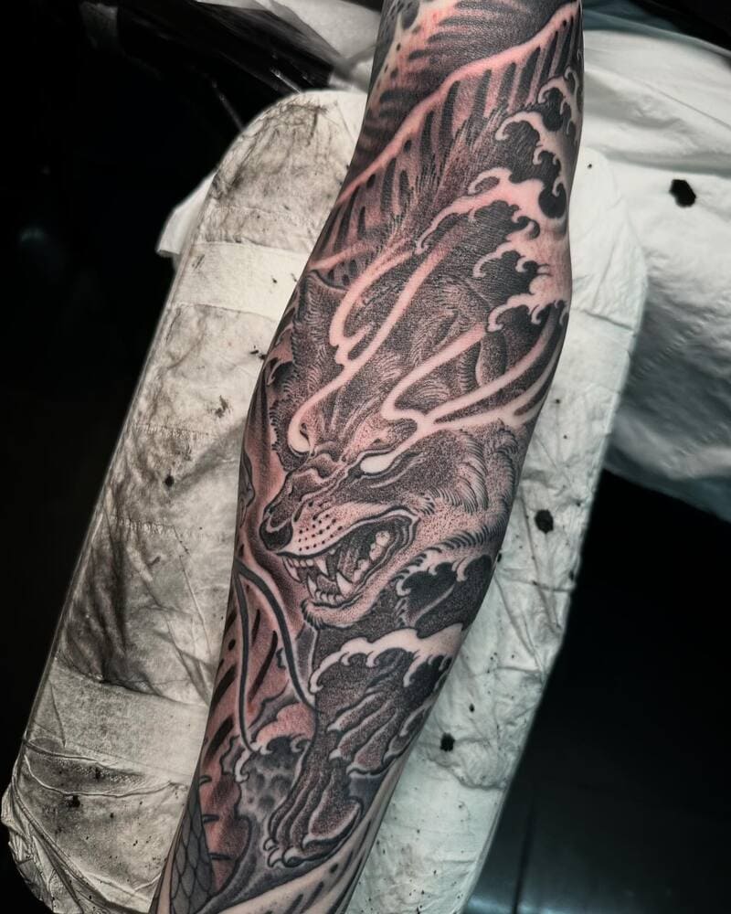 Japanese style wolf sleeve tattoo with wave elements for men