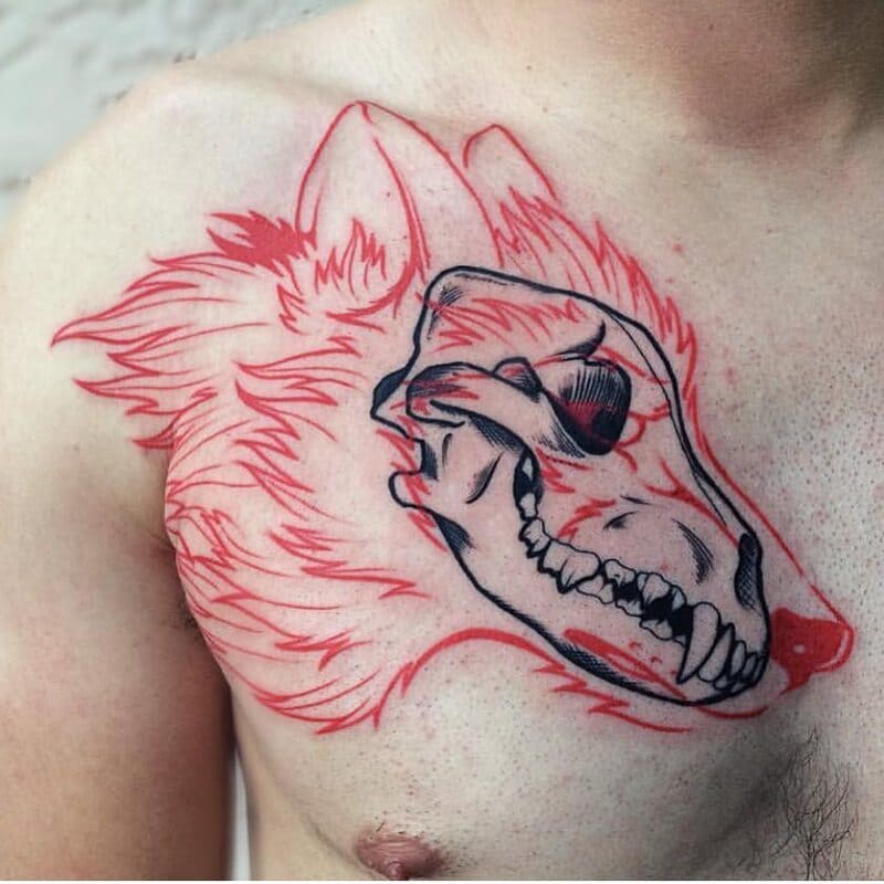 Red and black wolf skull chest tattoo for men