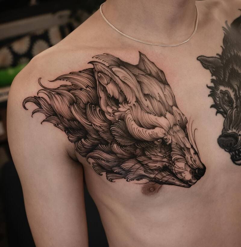 Artistic wolf profile shoulder tattoo with flowing lines for men