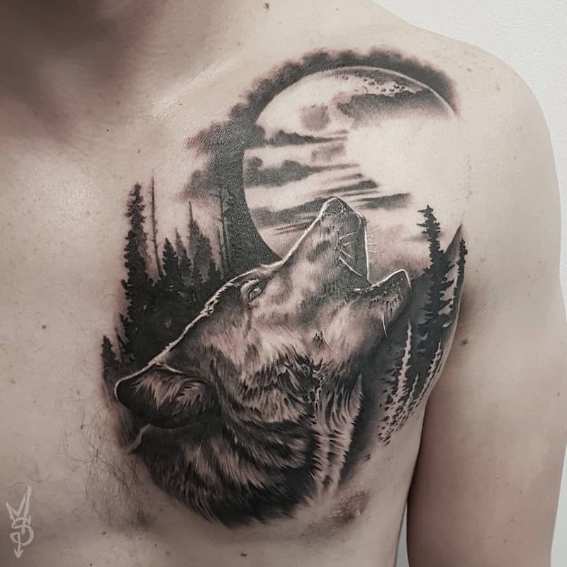 Chest howling wolf tattoo with forest scene for men