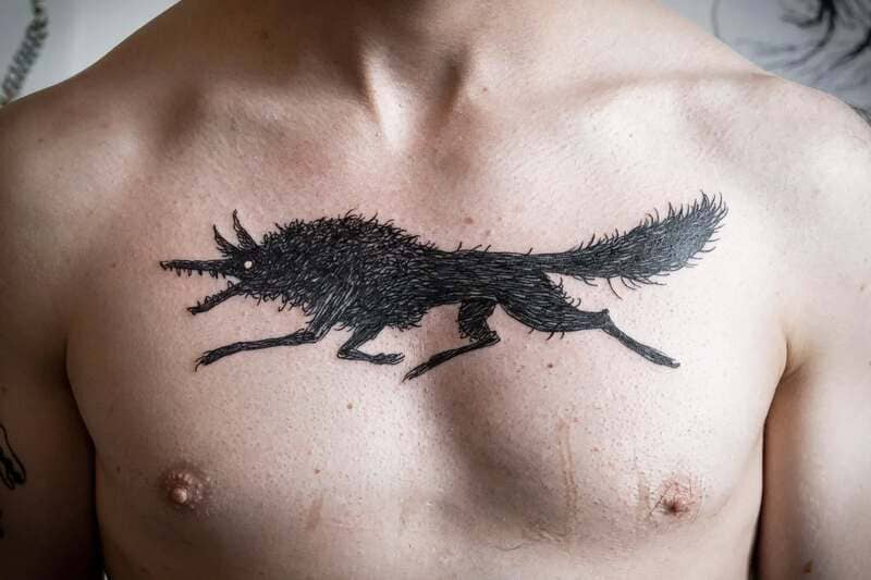 Minimalist running wolf silhouette chest tattoo for men
