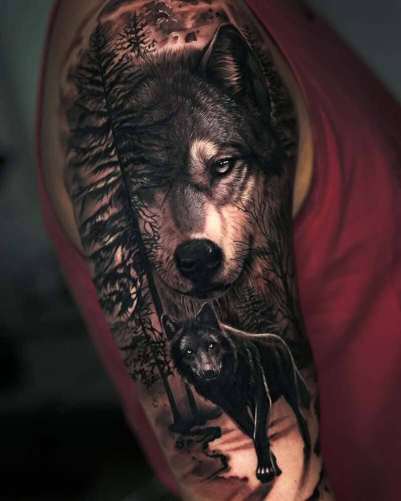 Realistic wolf forest scene arm tattoo for men