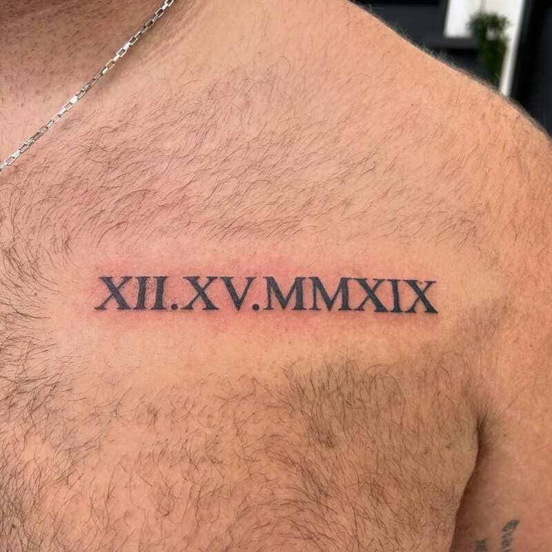 date-roman-numeral-small-chest-tattoo-men