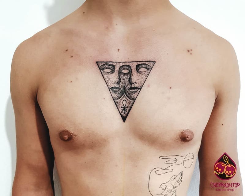 triangle-faces-small-center-chest-tattoo-men