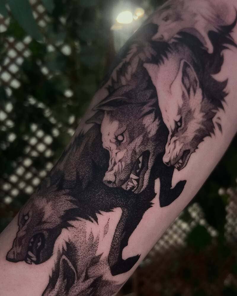 Black and grey wolf pack tattoo sleeve design for men