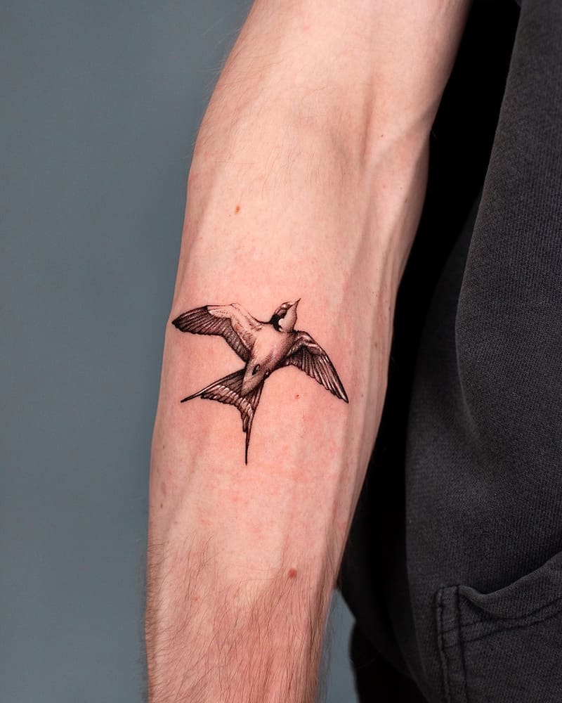 Single swallow forearm tattoo design for men