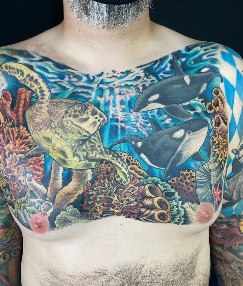 Colorful underwater ecosystem ocean chest tattoo for men with turtles and orcas