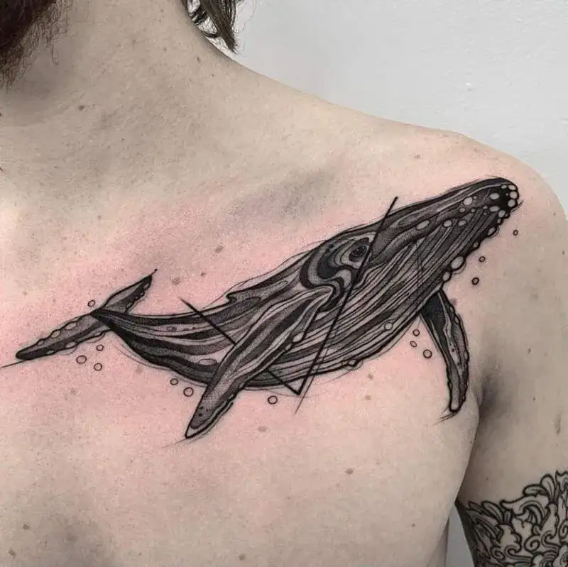 Sketch style humpback whale ocean chest tattoo for men with artistic line work