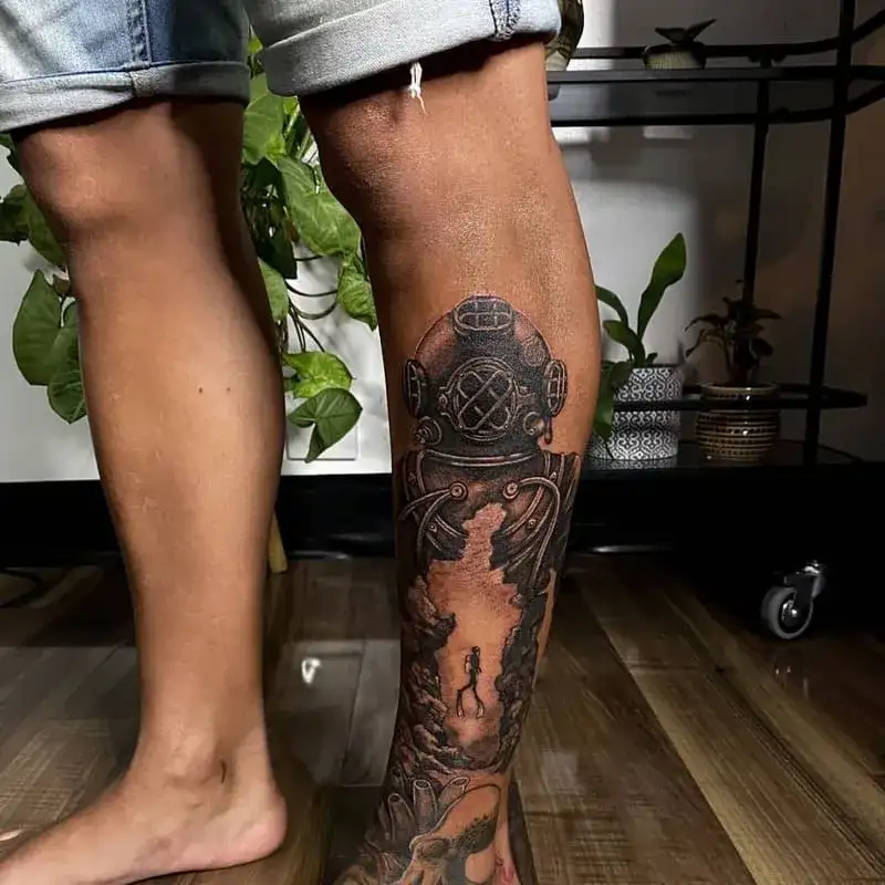Vintage diving helmet ocean leg tattoo for men with underwater cave exploration scene
