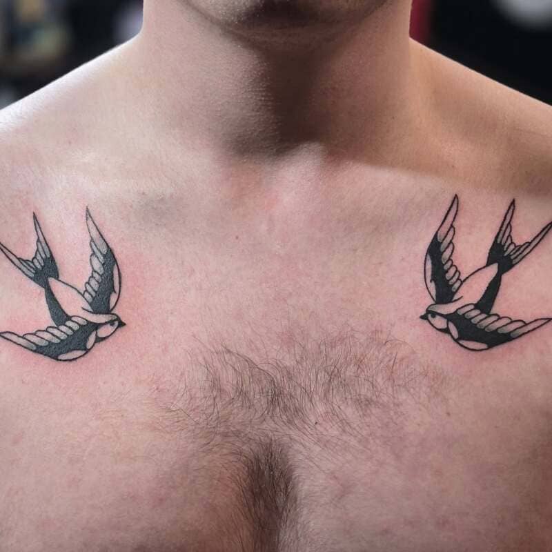 Traditional navy swallow chest tattoo design for men