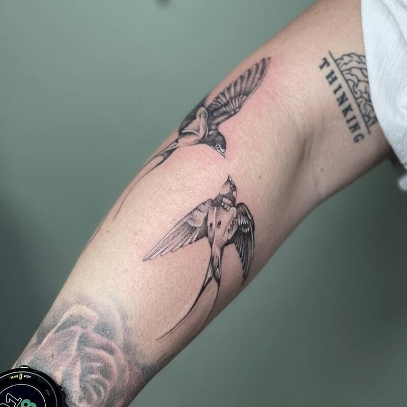 Paired swallow forearm tattoo design for men