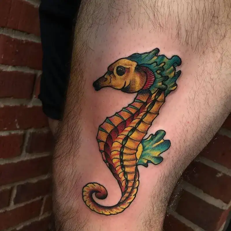 Colorful seahorse ocean leg tattoo for men with vibrant yellow and teal design