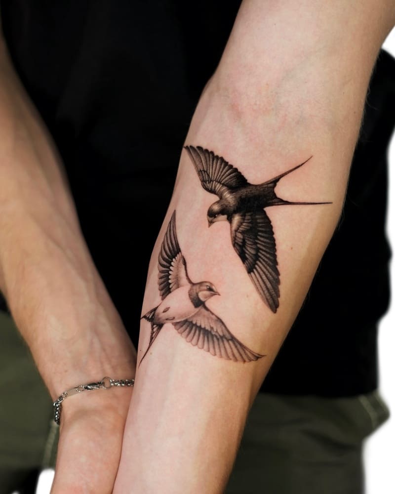 Wing detailed swallow wrist tattoo design for men