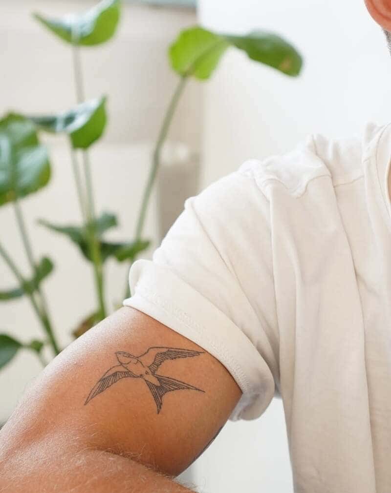 Simple line swallow arm tattoo design for men