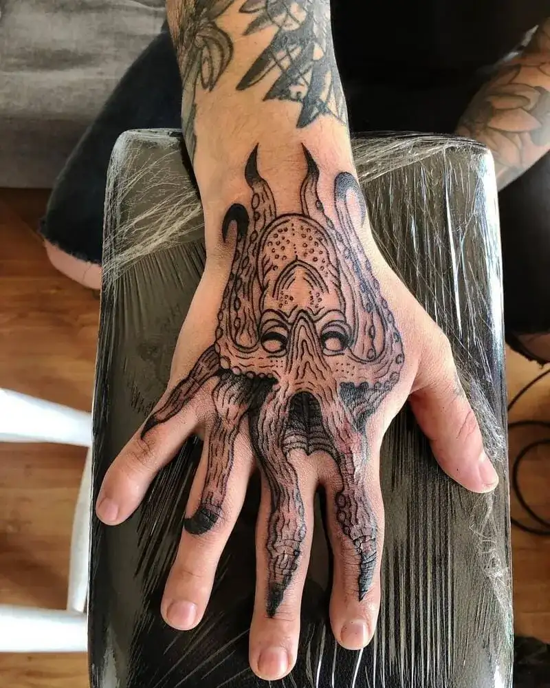 Octopus monster hand ocean tattoo for men with tentacles extending down fingers