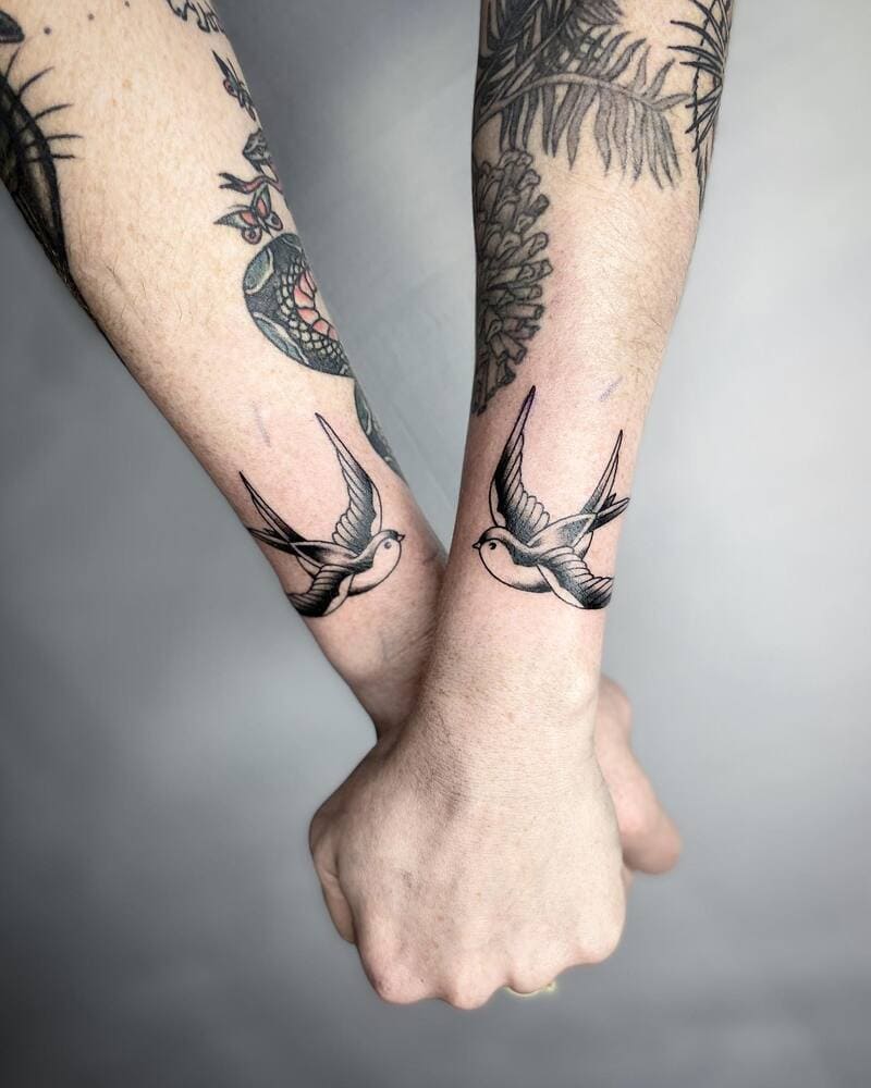 Matching swallow wrist tattoo design for men
