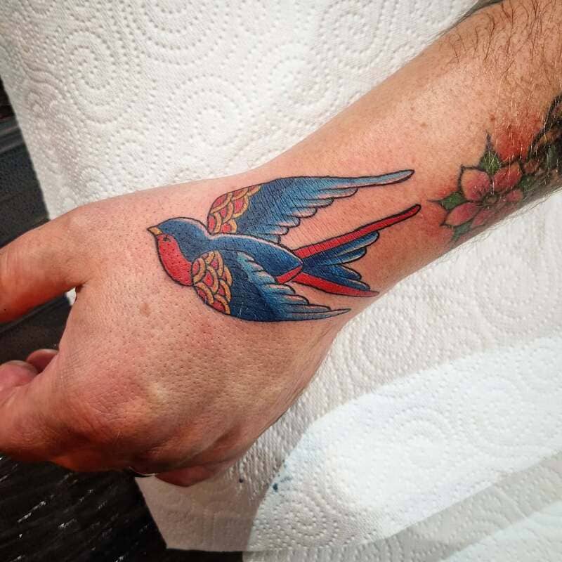 Colorful Sailor Jerry swallow hand tattoo design for men