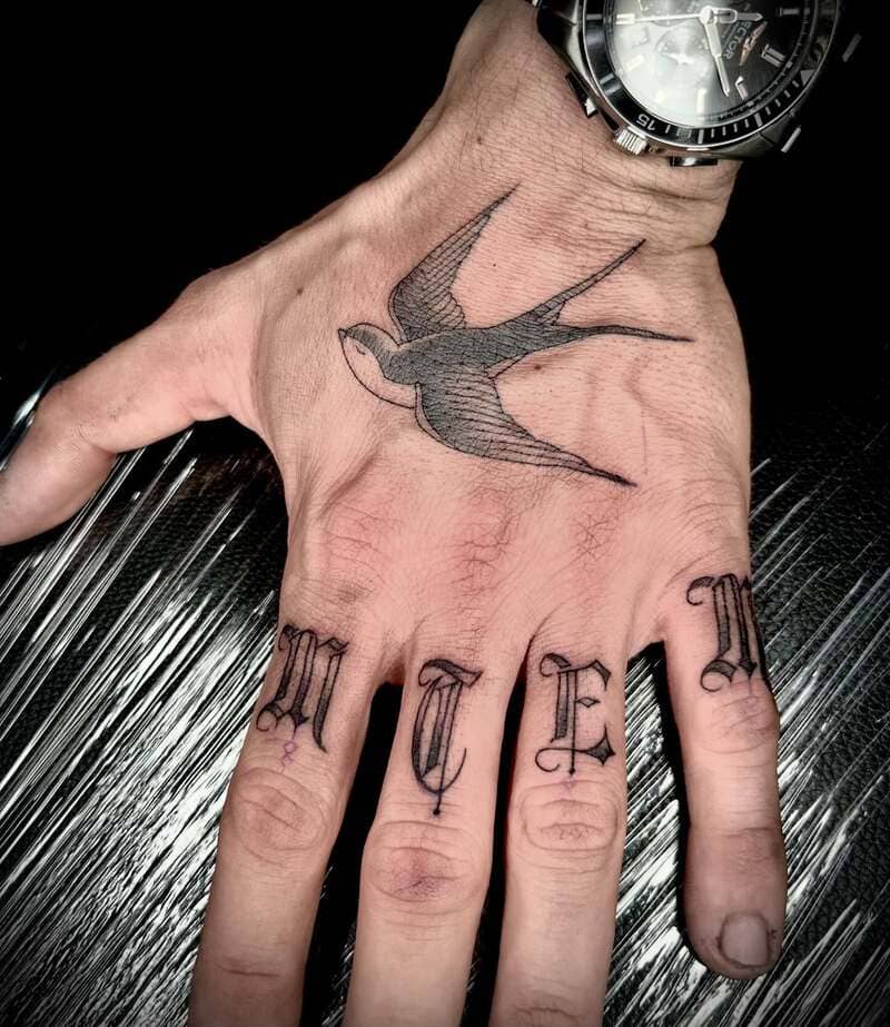 Lettered swallow hand tattoo design for men