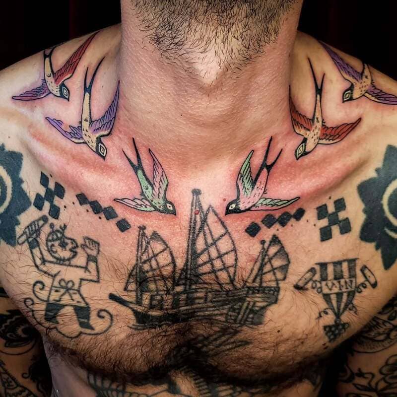 Colorful maritime swallow chest tattoo design for men
