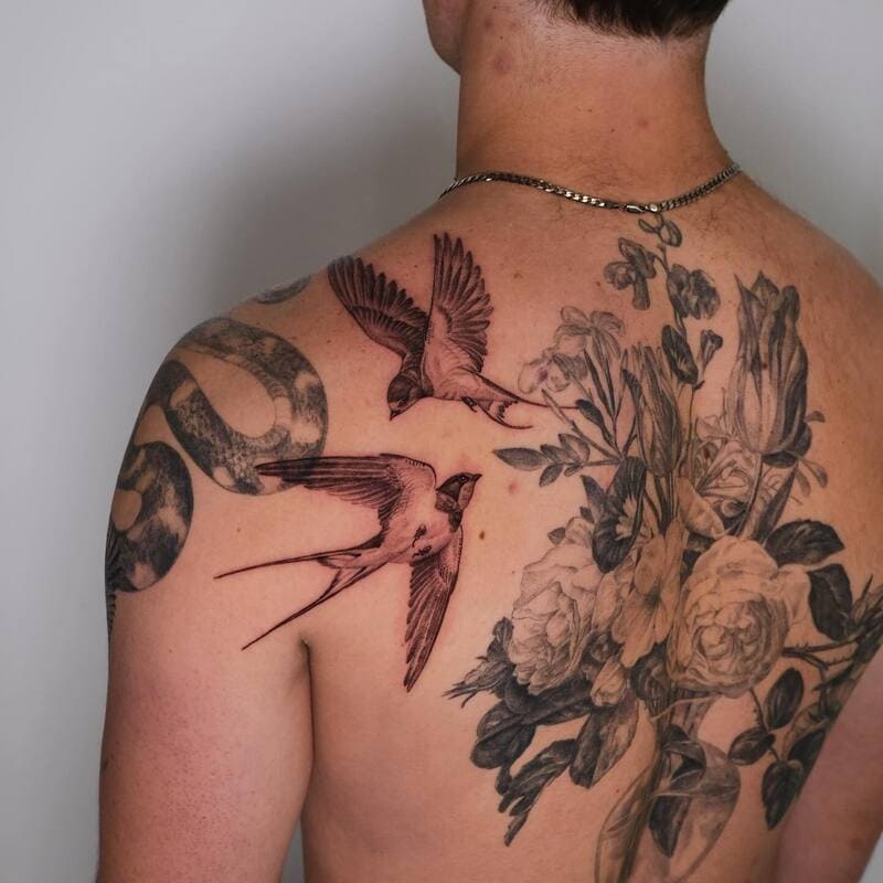 Floral neo traditional swallow back tattoo design for men
