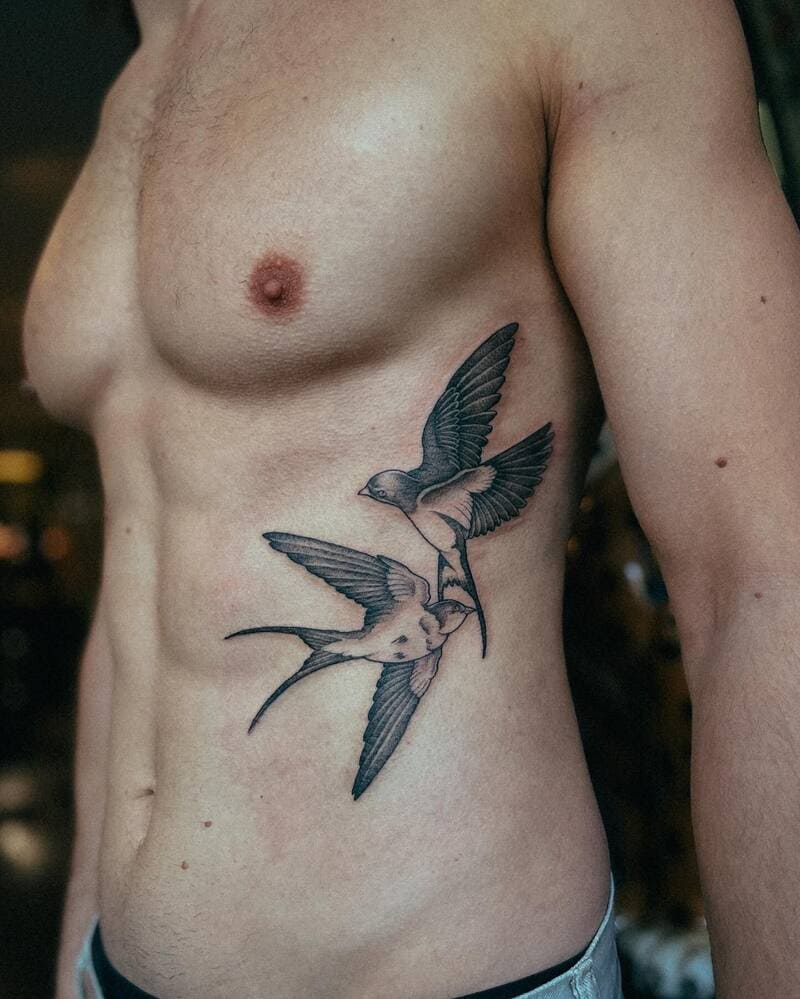 Dynamic motion swallow torso tattoo design for men