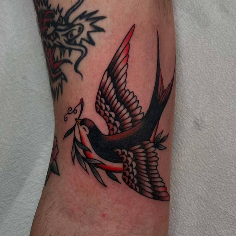 Nature inspired neo traditional swallow arm tattoo design for men