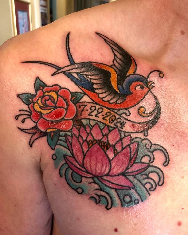 Traditional swallow tattoo with rose and lotus flowers