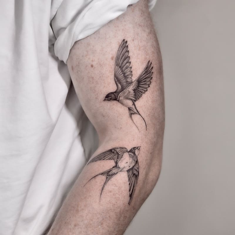 Fine line paired swallow outer arm tattoo design for men