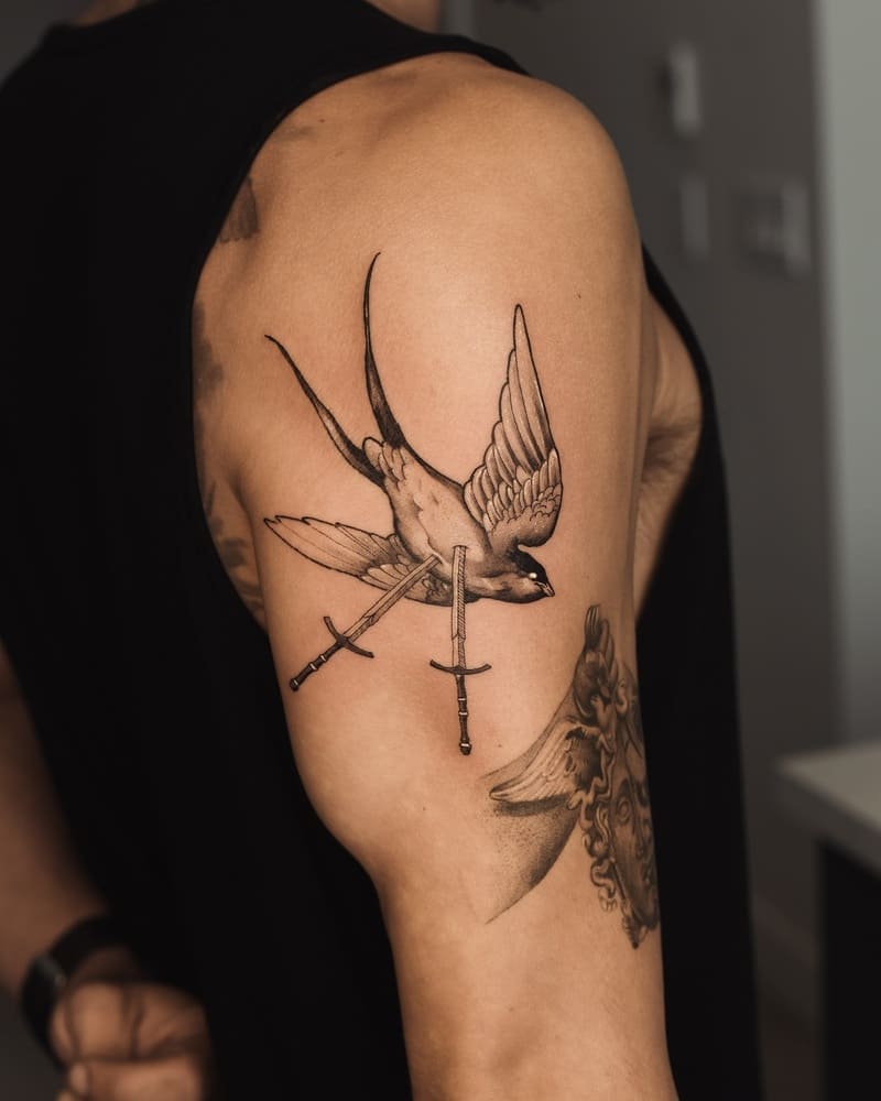 Crossed swords swallow upper arm tattoo design for men