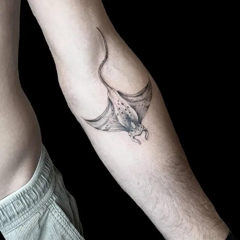 Minimalist manta ray fine line ocean tattoo for men with blue accent